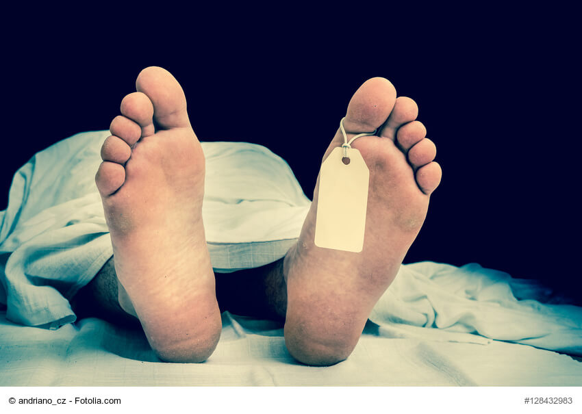 The dead man's body with blank tag on feet under white cloth